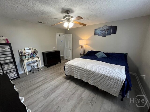 43 Fabian Ln, Hinesville, GA 31313 - bedroom with light wood-style flooring, baseboards, a textured ceiling, and a ceiling fan
