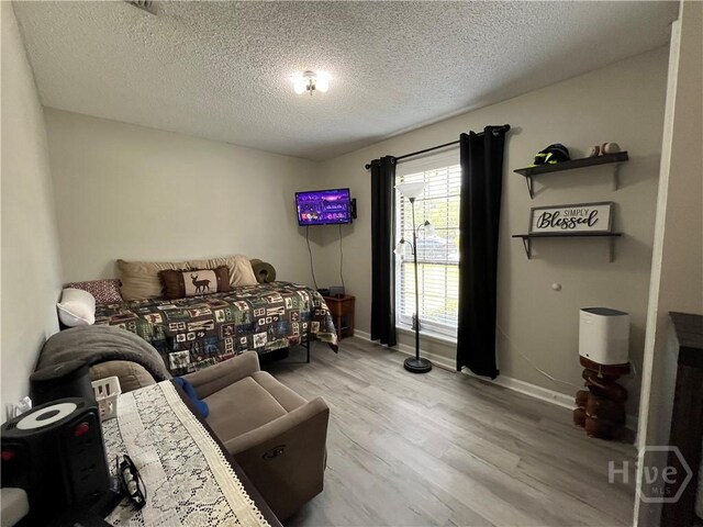 43 Fabian Ln, Hinesville, GA 31313 - bedroom featuring wood finished floors, a textured ceiling, and baseboards