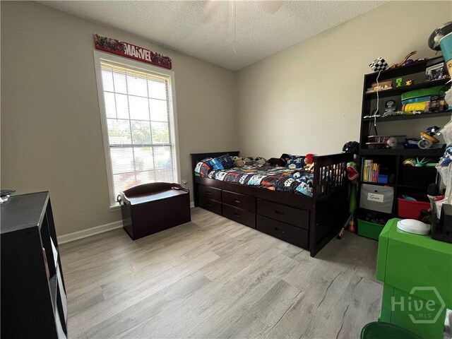 43 Fabian Ln, Hinesville, GA 31313 - bedroom with light wood-type flooring and a textured ceiling