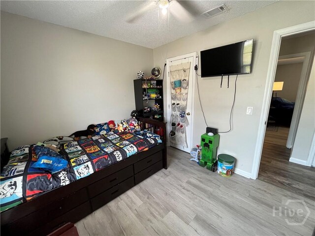 43 Fabian Ln, Hinesville, GA 31313 - bedroom featuring wood finished floors, a textured ceiling, ceiling fan, and baseboards