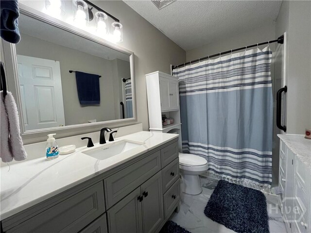 43 Fabian Ln, Hinesville, GA 31313 - full bathroom featuring vanity, marble look tile flooring, toilet, a textured ceiling, and a shower with shower curtain