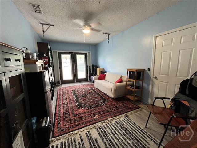 43 Fabian Ln, Hinesville, GA 31313 - living room featuring ceiling fan, a textured ceiling, french doors, and wood finished floors
