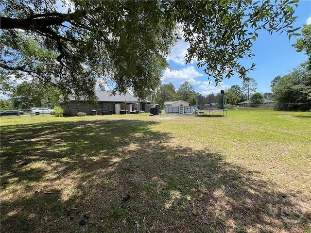 43 Fabian Ln, Hinesville, GA 31313 - view of yard featuring a trampoline