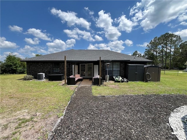 43 Fabian Ln, Hinesville, GA 31313 - rear view of property with french doors, cooling unit, a yard, and a shingled roof