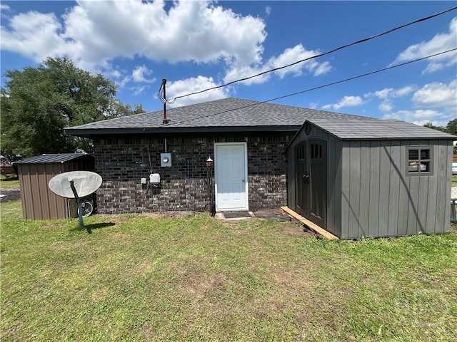 43 Fabian Ln, Hinesville, GA 31313 - back of property with a yard, roof with shingles, and brick siding