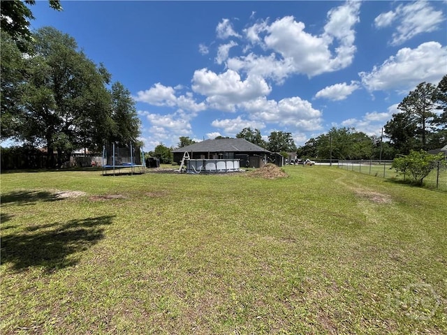 43 Fabian Ln, Hinesville, GA 31313 - view of yard featuring a trampoline