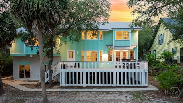 108 San Marco Dr, Tybee Island, GA 31328 - back of house at dusk with a metal roof and stairway