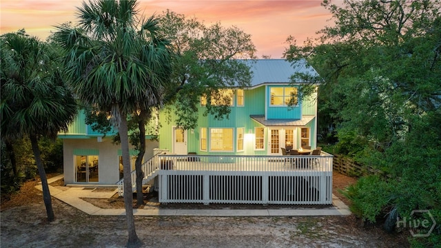 108 San Marco Dr, Tybee Island, GA 31328 - back of property at dusk featuring metal roof