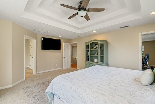 108 San Marco Dr, Tybee Island, GA 31328 - bedroom with a tray ceiling, light colored carpet, recessed lighting, baseboards, and ceiling fan