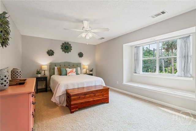 108 San Marco Dr, Tybee Island, GA 31328 - bedroom with light colored carpet, baseboards, a textured ceiling, and ceiling fan