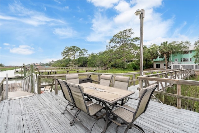 108 San Marco Dr, Tybee Island, GA 31328 - wooden deck with outdoor dining space and a water view