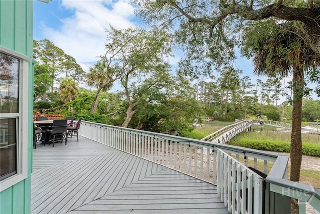 108 San Marco Dr, Tybee Island, GA 31328 - deck with outdoor dining area and view of wooded area