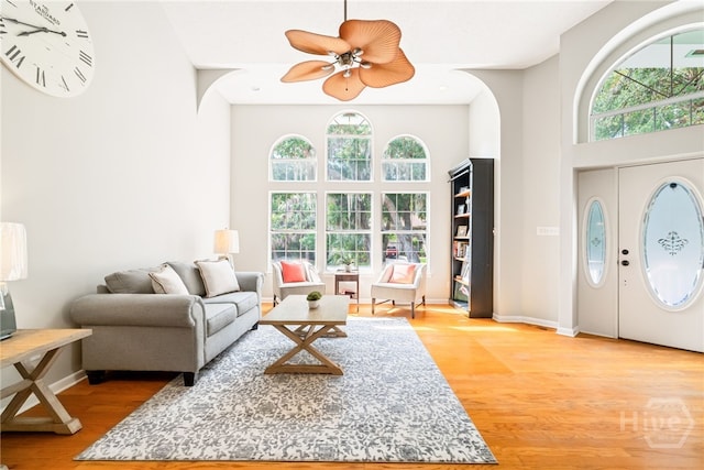 108 San Marco Dr, Tybee Island, GA 31328 - living room featuring light wood-style flooring, healthy amount of natural light, a high ceiling, ceiling fan, and baseboards