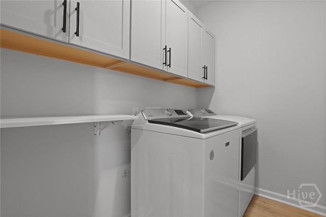 73 Small Pine Ln, Richmond Hill, GA 31324 - laundry room featuring washer and clothes dryer, cabinet space, baseboards, and light wood finished floors