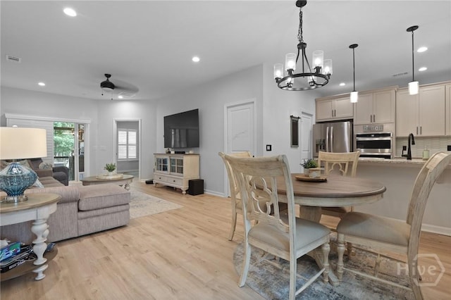 73 Small Pine Ln, Richmond Hill, GA 31324 - dining area featuring a chandelier, recessed lighting, light wood-style flooring, ceiling fan, and baseboards