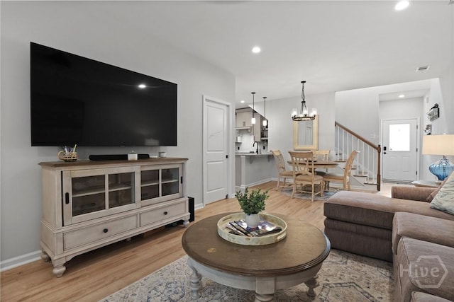 73 Small Pine Ln, Richmond Hill, GA 31324 - living area featuring wood finished floors, a chandelier, stairway, baseboards, and recessed lighting