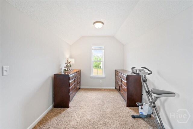 821 NE Mustang Ln, Ludowici, GA 31316 - bedroom featuring light colored carpet, lofted ceiling, and a textured ceiling