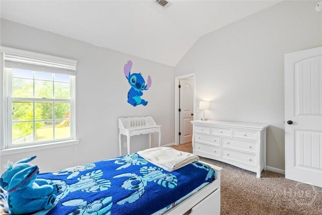 821 NE Mustang Ln, Ludowici, GA 31316 - bedroom with vaulted ceiling, light carpet, and baseboards