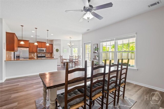 821 NE Mustang Ln, Ludowici, GA 31316 - dining room featuring wood finished floors, recessed lighting, a chandelier, and a ceiling fan