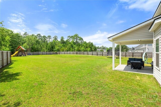 821 NE Mustang Ln, Ludowici, GA 31316 - view of yard with a patio and a playground