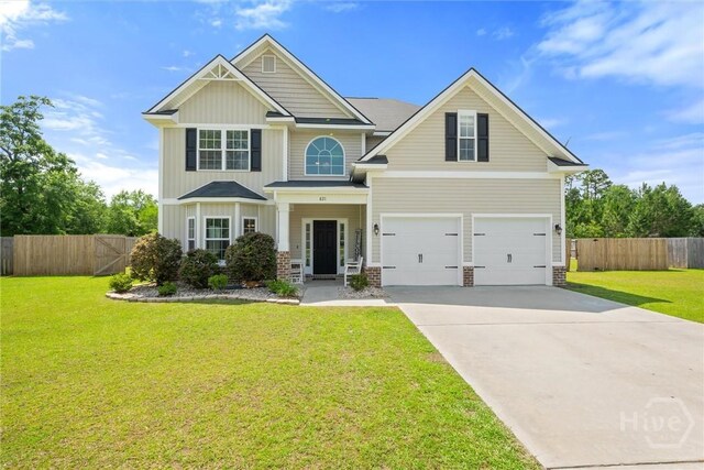 821 NE Mustang Ln, Ludowici, GA 31316 - craftsman-style house featuring driveway, an attached garage, and board and batten siding