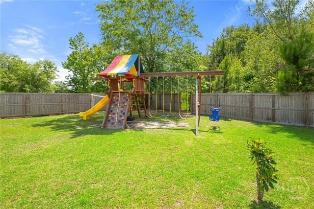 821 NE Mustang Ln, Ludowici, GA 31316 - view of jungle gym with a fenced backyard
