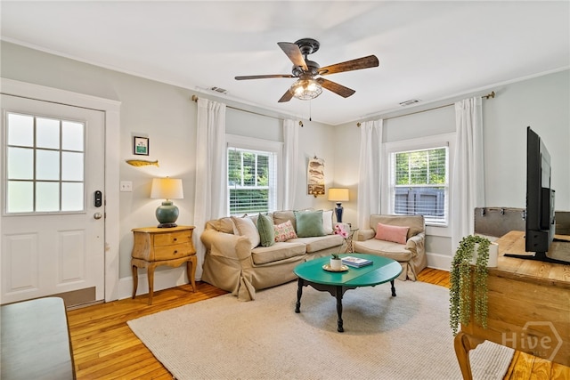 2609 Bismark Ave, Savannah, GA 31406 - living room with healthy amount of natural light, light wood finished floors, a ceiling fan, and baseboards