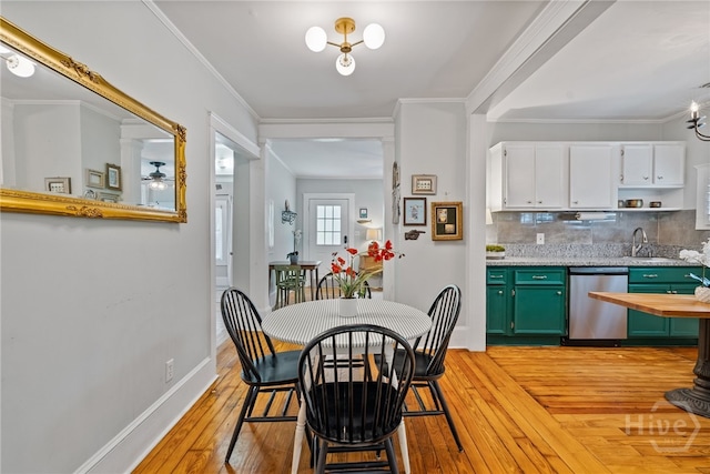 2609 Bismark Ave, Savannah, GA 31406 - dining room featuring light wood-type flooring, a ceiling fan, baseboards, and crown molding