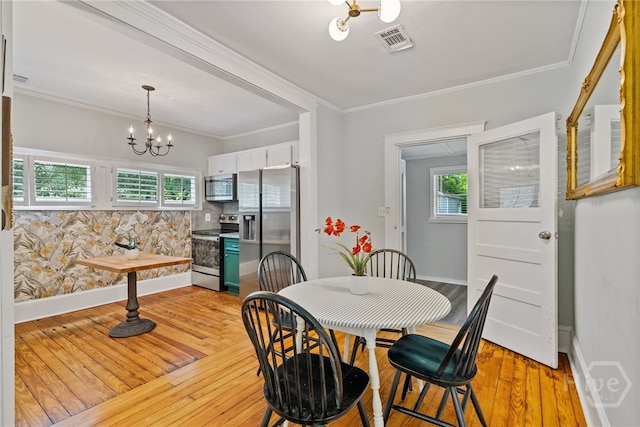 2609 Bismark Ave, Savannah, GA 31406 - dining space with a chandelier, baseboards, light wood-style floors, and crown molding