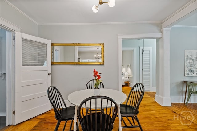2609 Bismark Ave, Savannah, GA 31406 - dining room featuring ornamental molding, decorative columns, baseboards, and wood finished floors