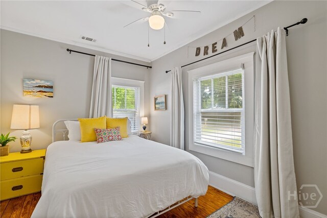 2609 Bismark Ave, Savannah, GA 31406 - bedroom with wood finished floors, ornamental molding, ceiling fan, and baseboards