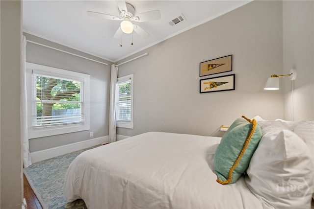 2609 Bismark Ave, Savannah, GA 31406 - bedroom with multiple windows, baseboards, ornamental molding, ceiling fan, and wood finished floors