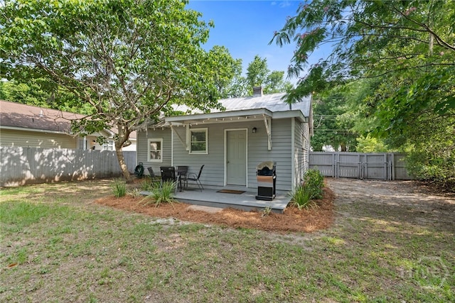 2609 Bismark Ave, Savannah, GA 31406 - back of house featuring a patio, a gate, a chimney, and metal roof