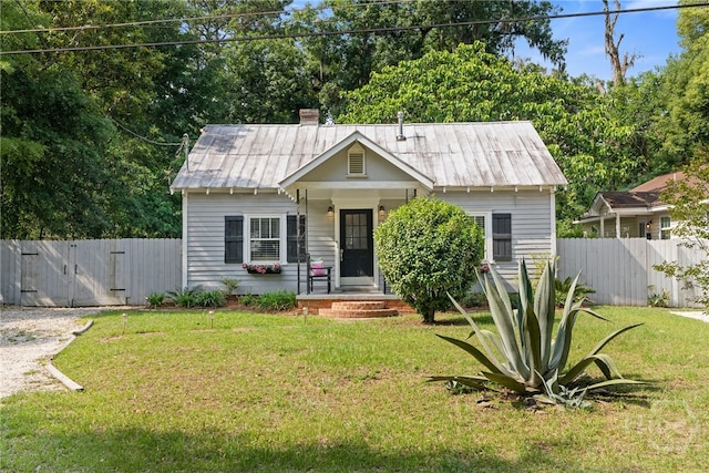 2609 Bismark Ave, Savannah, GA 31406 - bungalow-style home featuring a gate, metal roof, and a chimney