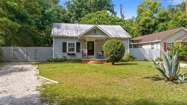 2609 Bismark Ave, Savannah, GA 31406 - bungalow-style home with a gate, a porch, metal roof, and a chimney