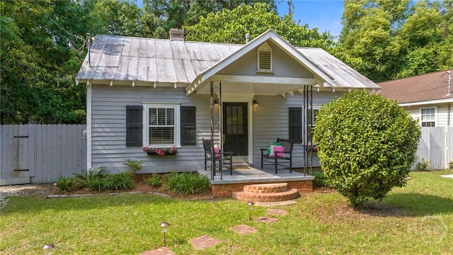 2609 Bismark Ave, Savannah, GA 31406 - bungalow-style home featuring metal roof, a porch, and a chimney