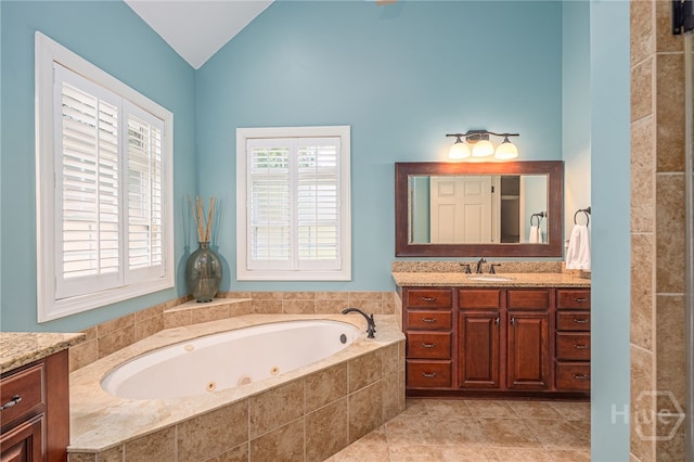 10 Flanders Dr, Richmond Hill, GA 31324 - full bathroom featuring vaulted ceiling, vanity, a jetted tub, and tile patterned floors
