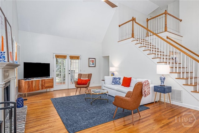 8720 Ferguson Ave, Savannah, GA 31406 - living area with high vaulted ceiling, stairway, wood finished floors, a fireplace, and baseboards