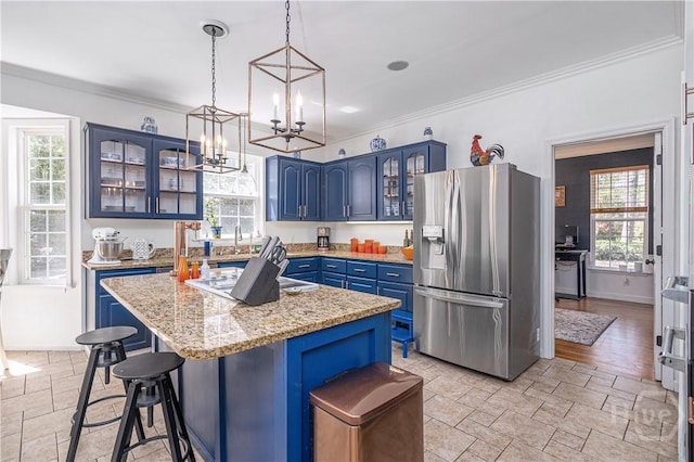 8720 Ferguson Ave, Savannah, GA 31406 - kitchen featuring stainless steel refrigerator with ice dispenser, blue cabinetry, ornamental molding, plenty of natural light, and a chandelier