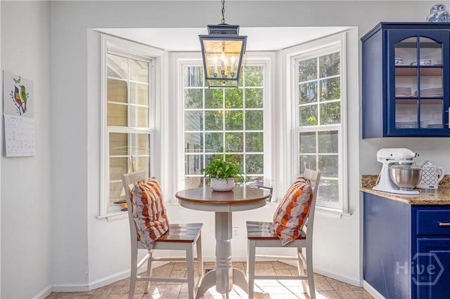 8720 Ferguson Ave, Savannah, GA 31406 - dining space with baseboards, a chandelier, and light tile patterned floors