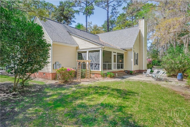 8720 Ferguson Ave, Savannah, GA 31406 - rear view of property featuring a patio area, a sunroom, a shingled roof, a lawn, and a chimney