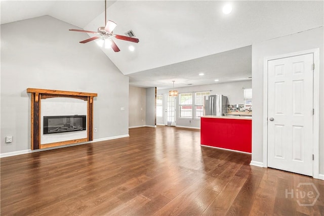 125 Crossing Cir, Rincon, GA 31326 - unfurnished living room with ceiling fan, recessed lighting, wood finished floors, high vaulted ceiling, and a glass covered fireplace