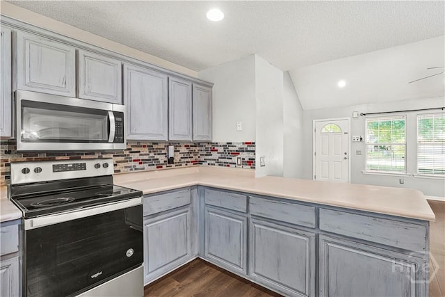 125 Crossing Cir, Rincon, GA 31326 - kitchen featuring appliances with stainless steel finishes, gray cabinets, a peninsula, light countertops, and lofted ceiling