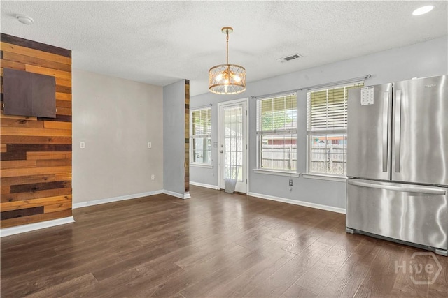 125 Crossing Cir, Rincon, GA 31326 - unfurnished dining area featuring baseboards, a textured ceiling, wood finished floors, and a chandelier