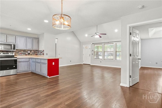 125 Crossing Cir, Rincon, GA 31326 - kitchen featuring stainless steel appliances, gray cabinetry, ceiling fan, a peninsula, and tasteful backsplash
