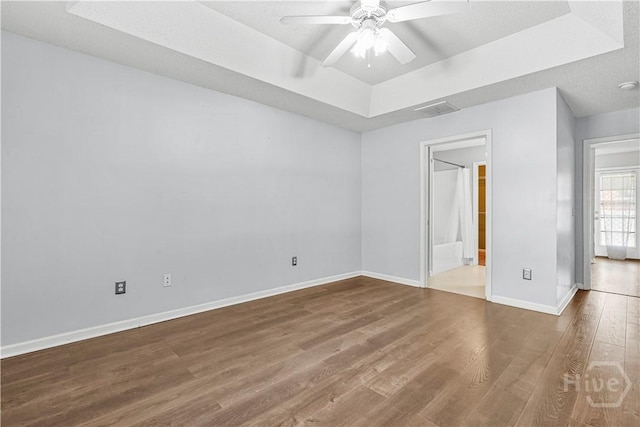125 Crossing Cir, Rincon, GA 31326 - spare room with a raised ceiling, wood finished floors, ceiling fan, and baseboards