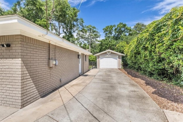 2 Penrose Pt, Savannah, GA 31410 - view of home's exterior with a garage, an outbuilding, concrete driveway, and brick siding