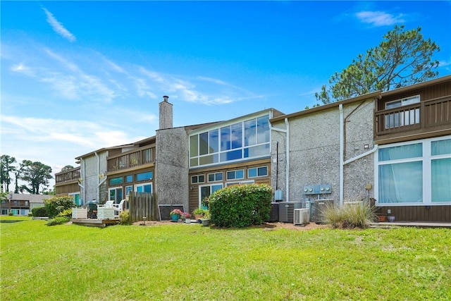 104 Bull River Bluff Dr Unit 104, Savannah, GA 31410 - back of property featuring a chimney, a yard, and central air condition unit