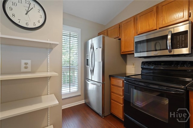 104 Bull River Bluff Dr Unit 104, Savannah, GA 31410 - kitchen featuring stainless steel appliances, dark wood-style flooring, brown cabinets, baseboards, and vaulted ceiling