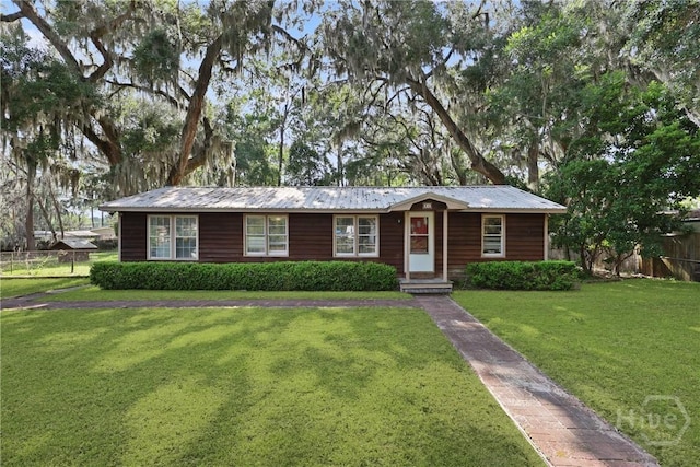 24 Mimosa St, Midway, GA 31320 - ranch-style home featuring metal roof